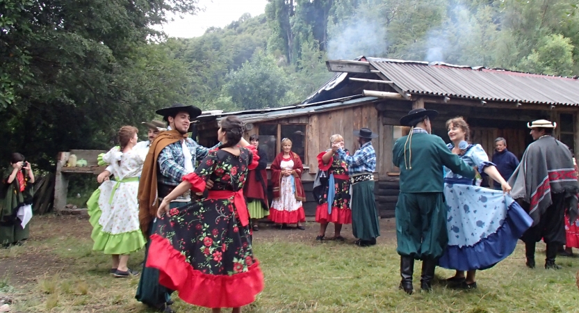 A group of people dance outdoors.